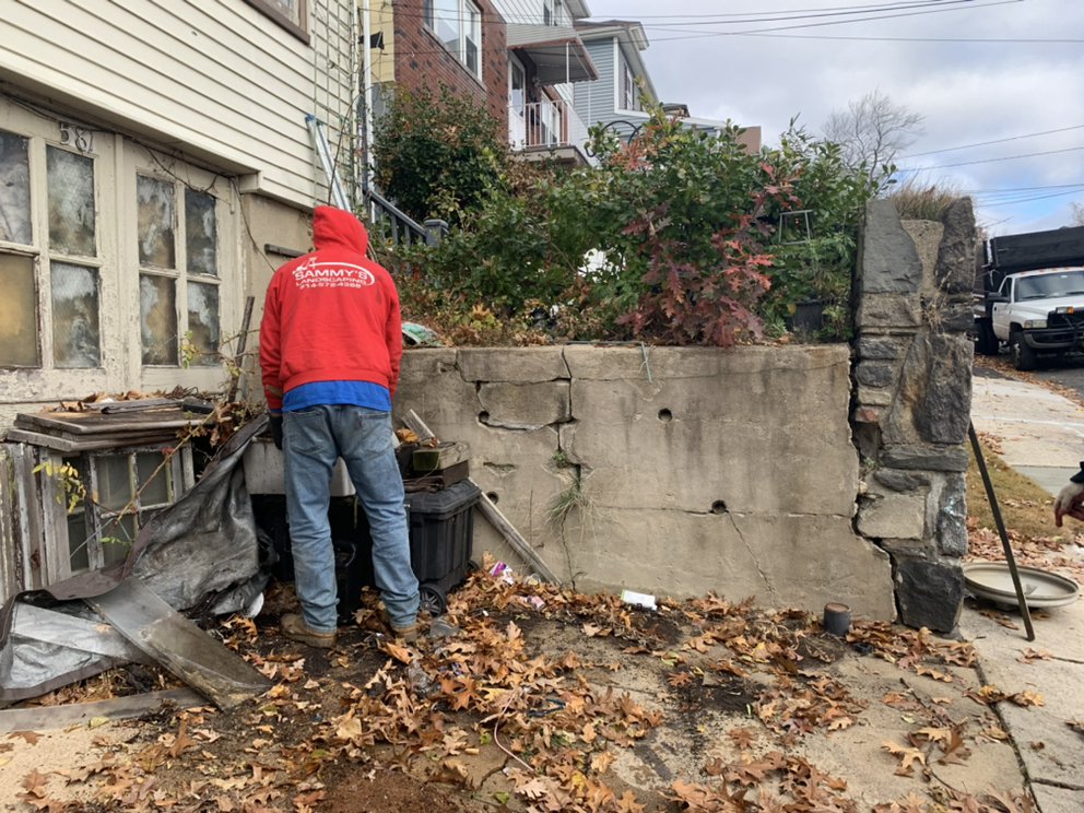 Sammy's Landscaping team member preparing yard for seasonal cleanup